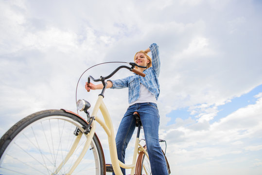 Girl rides bicycle sky background. Most satisfying form of self transportation. Enjoy cycling cruiser bike. Woman feels free while enjoy cycling. Cycling gives you feeling of freedom and independence