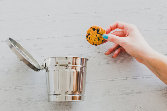 Hand Throwing Website Cookie Going Into A Trash Can