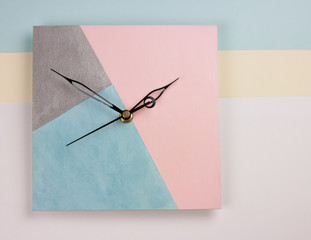 Creative bright top view with wall clock on the pink and blue background. Flat lay