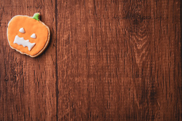 Fresh delicious homemade decorated halloween cookies sweets on dark wooden background, concept of halloween party, copy space(text space), top view, blank for text.