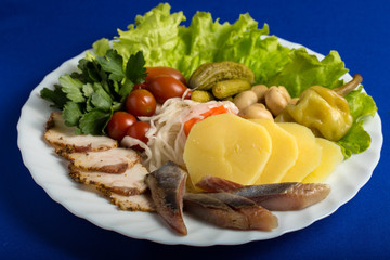 plate with snack on a white plate, isolated on blue background