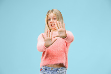 Reject, rejection, doubt concept. Young emotional teen girl at studio rejecting something against...