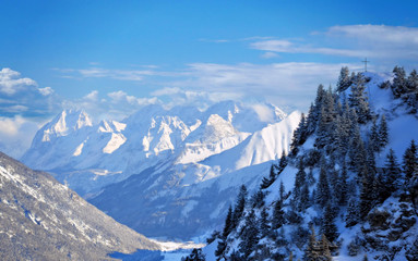beautiful alpine mountains in winter with blue sky