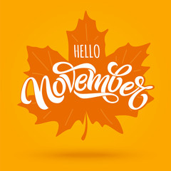 Hello November. Modern brush calligraphy with maple leaf on bright orange background. Vector lettering for greeting card, social media banner, print design. Editable vector illustration.