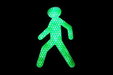 green pedestrian icon on black background