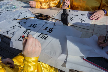 Chinese female hands writing Chinese calligraphy