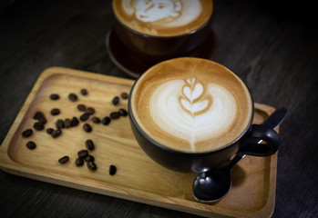Hot coffee on wooden tray