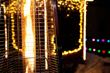 Gas heater on the background of Christmas lights