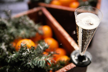 a glass of champagne and a box of tangerines