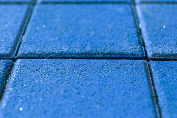 Paving slabs of pressed sandstone gray-blue. Photo of tiles on the square in the moonlight. Unusual...