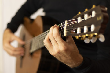 musician playing acoustic guitar