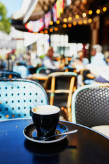 Cup of coffee in the table of French street cafe