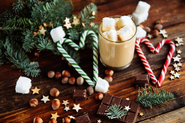 Cup with Christmas hot Chocolate drink, Marshmallows and cinnamon on wooden bright background. Holiday Gift concept, Top view