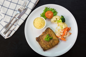 Meat steak with mashed potato and vegetable.