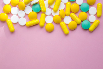 Fototapeta na wymiar closed up colorful antibiotic capsules pills tablets isolated on pink background, copy space