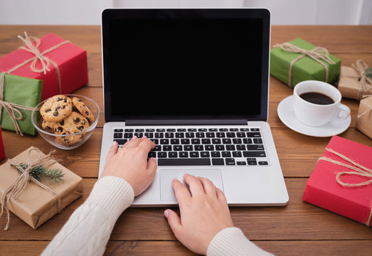 Preparing for Christmas. Woman buying presents on laptop, copy space