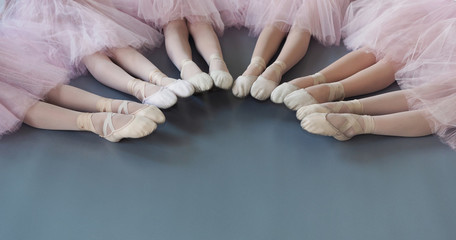 Ballerinas legs in pointe shoes on floor