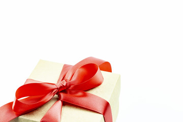 red satin ribbon on brown paper gift box with white  copy space 