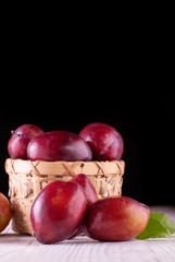 Sweet plums on wooden background
