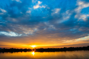 Naklejka na ściany i meble colorful dramatic sky with cloud at sunset.