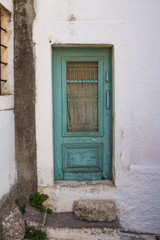 Fototapeta na wymiar White building with a green door, Crete, Greece
