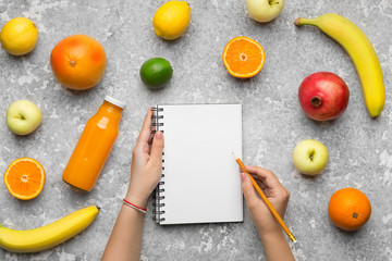 Naklejka na ściany i meble Healthy Food. Woman hand writing in blank notebook