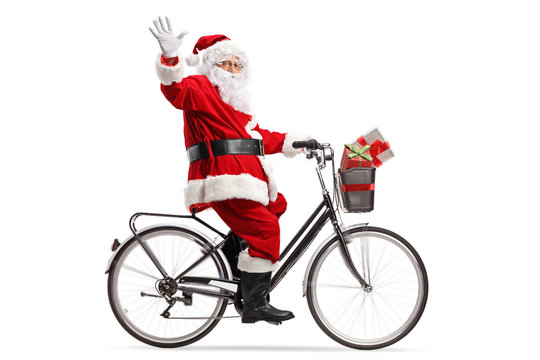 Santa Claus riding a bicycle and waving