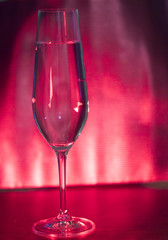 Champagne glass in disco party bar