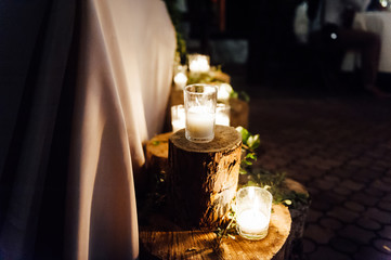 Rustic wedding decor on a timber background. Main table setting for bride and groom newlyweds