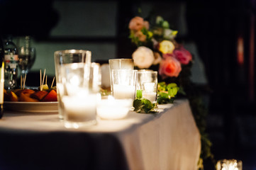 Rustic wedding decor on a timber background. Main table setting for bride and groom newlyweds