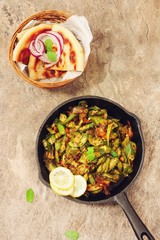 Homemade Bhindi Masala / Okra fry served with Roti, overhead view