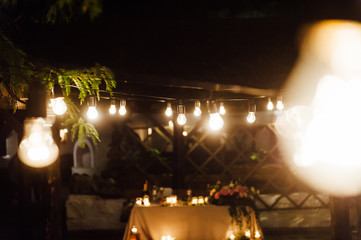 Light bulb decor in outdoor party. Wedding