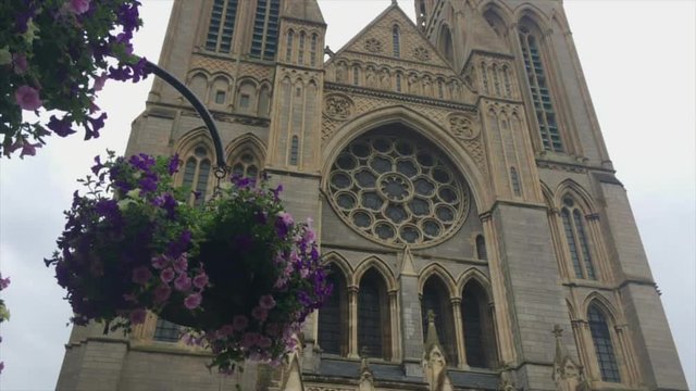 Tilt down from two towers to west porch of Truro Cathedral 