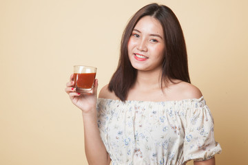 Young Asian woman drink tomato juice.