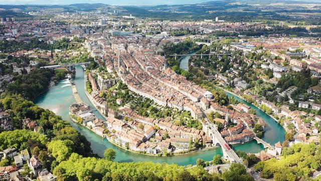 Aerial panoramic view of cityscape of Bern, historic city center above crook in turquoise river Aare - landscape panorama of capital city of Switzerland from above, Europe