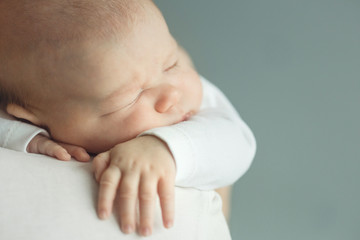 newborn baby sleeps on his shoulder dad. copy space, toned