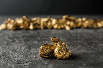 Gold nuggets on dark table