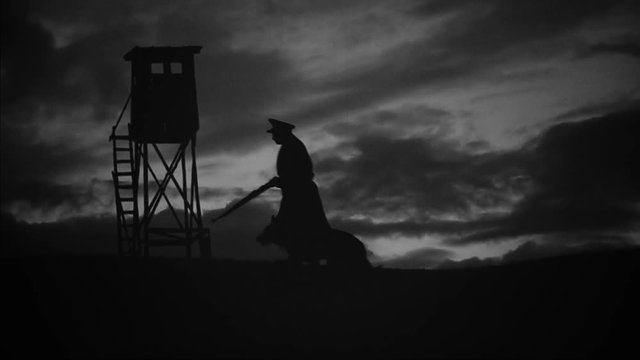 A communist militiaman guarding the border with his dog. Eastern Bloc Countries during the Cold War.