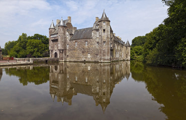 Fototapeta na wymiar Chateau de Trecesson, mirrored in the clear waters of its moat