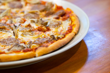 Fresh pizza with tomatoes, cheese and sausage