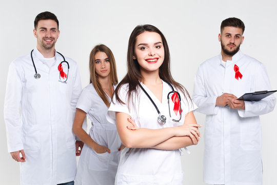 Group of doctors  with watercolor of red ribbon .world AIDS day concept. On the white background.