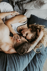 
Beautiful loving couple kissing in bed