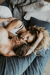 
Beautiful loving couple kissing in bed