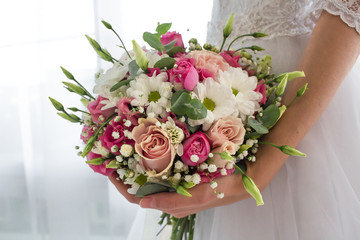 Wedding flowers bouquet in bride's hands
