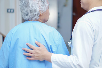 Doctor touching Asian senior or elderly old lady woman patient with love, care, encourage and...
