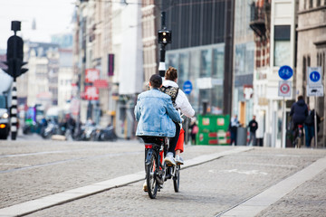 Cyclist in a cold early spring day at the Old Central district of Amsterdam