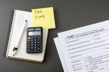 tax return form income calculator, pen and yellow sticker Business and tax concept