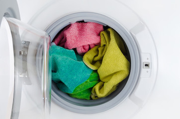 washing machine with color towels, clothes, open