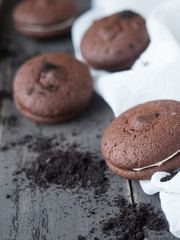 Chocolate cookies and brownie biscuit on black wood table.
