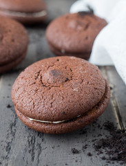 Chocolate cookies and brownie biscuit on black wood table.